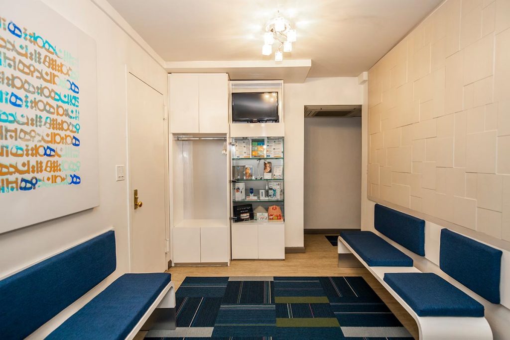 Sutton Place front desk area with blue sofa and decorations in dental office.