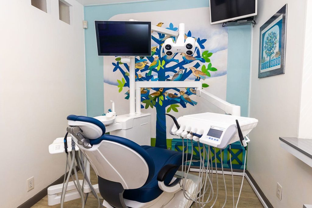 Dental exam room with dental chair and other dental equipment.